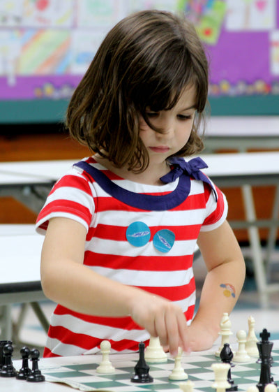 Little girl playing chess